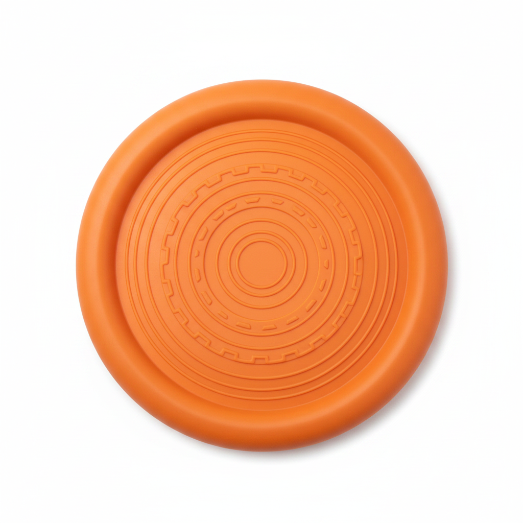 Top-down view of orange rubber dog frisbee showing textured grip surface