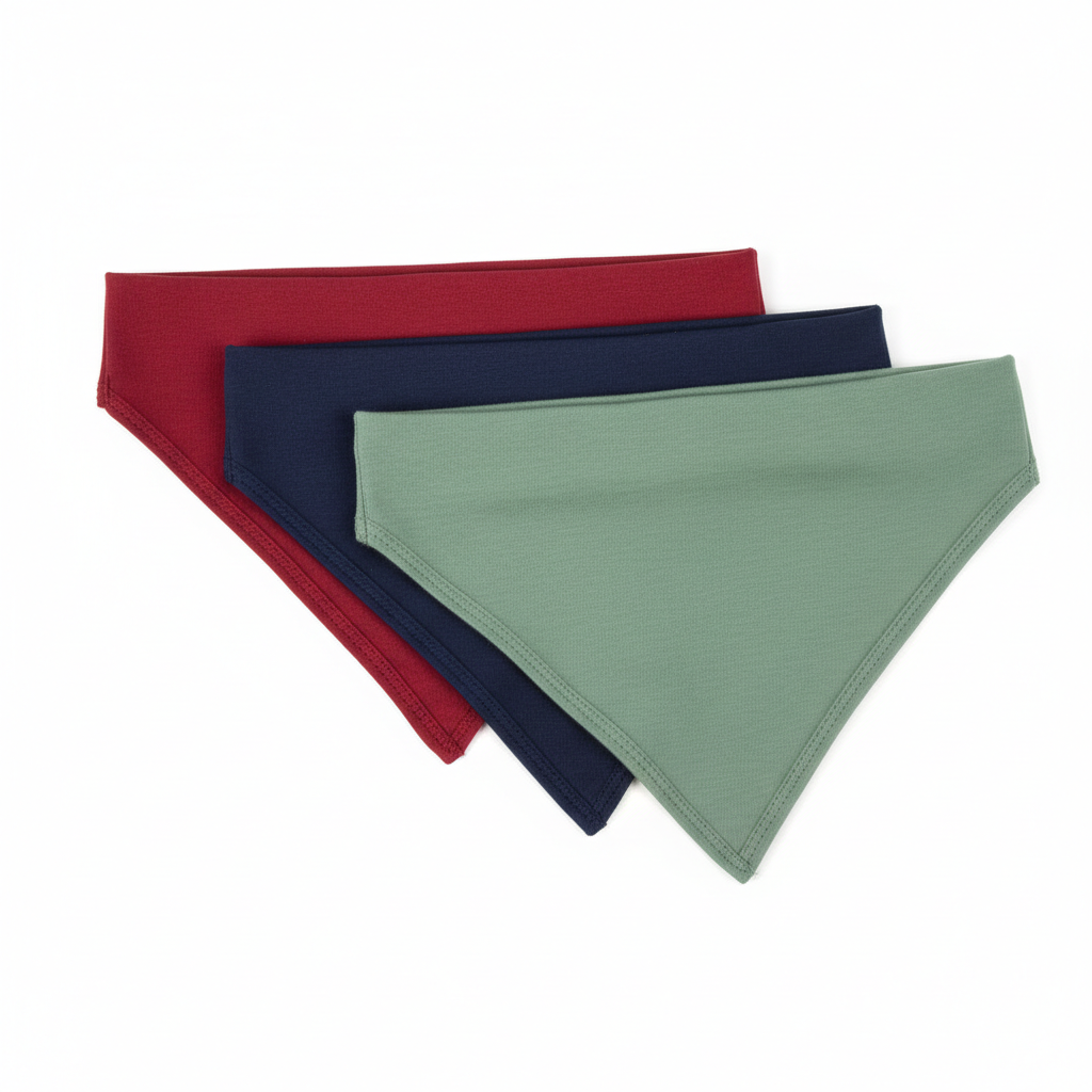Three pet bandanas in red, navy blue and sage green displayed together